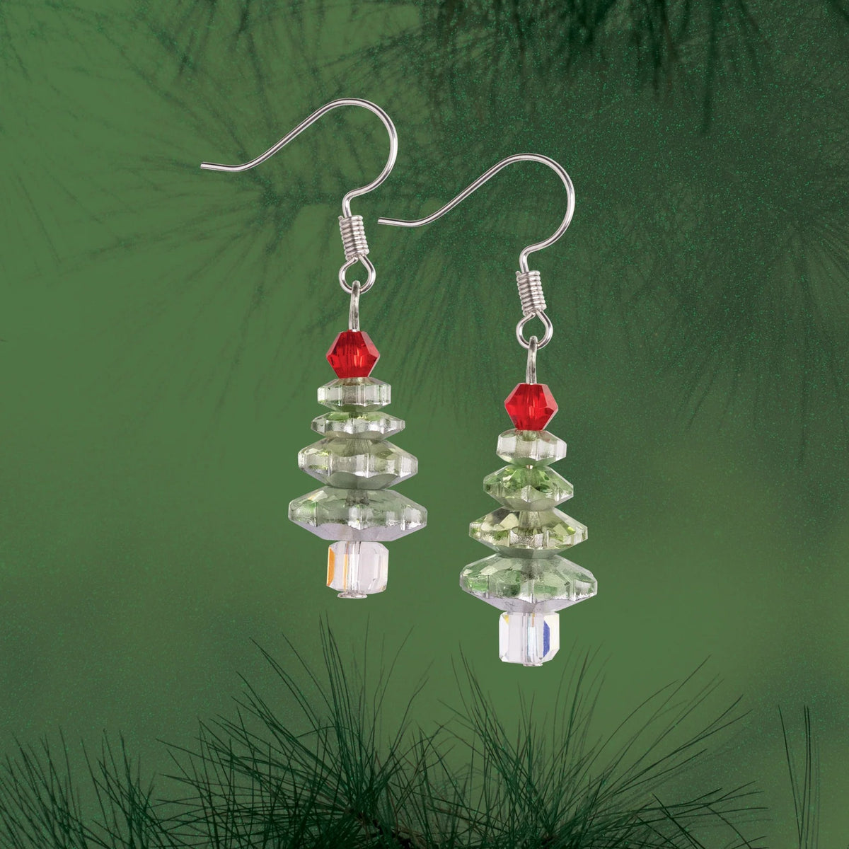 Solid Oak Nostalgic Christmas kit featuring Christmas tree earrings with soft green crystals and colourful bead accents, green background
