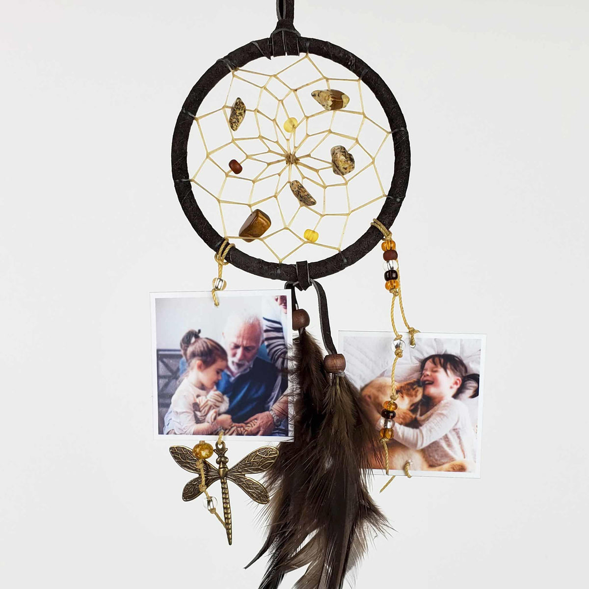 Finished nurture dream catcher with dark hoops, beads, feather tassels and small keepsake photos